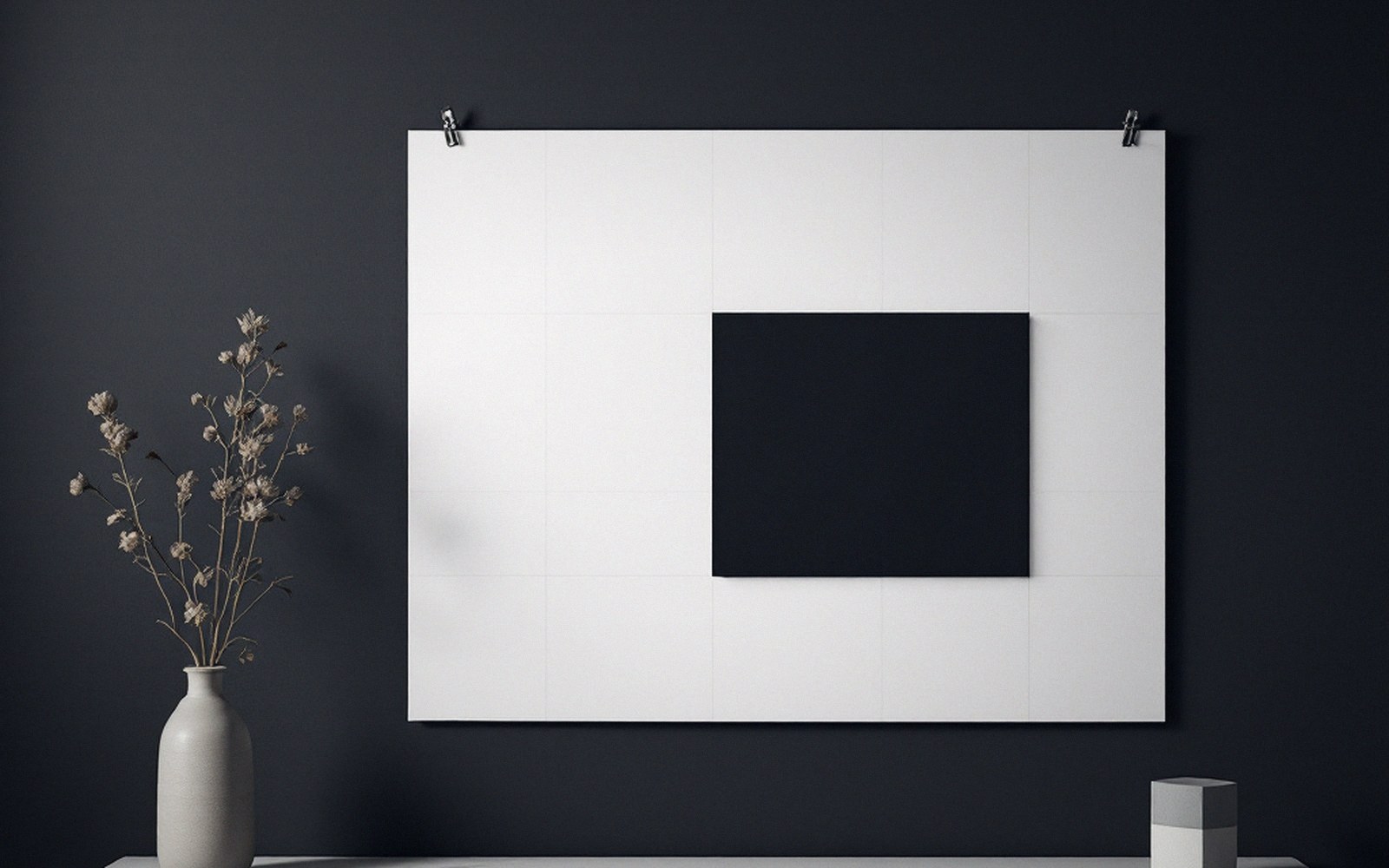 A dark rectangular canvas mounted off-center on a large white gridded sheet