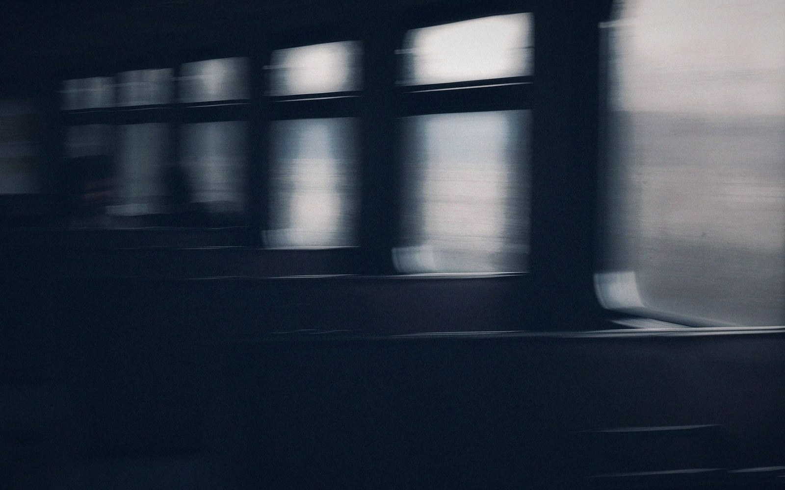 Motion blur of train windows and carriage side as it speeds past