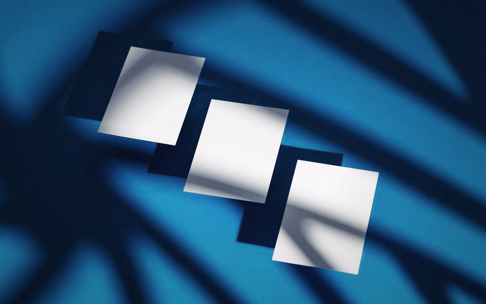 A hard-edged shadow cast across a plain coloured card