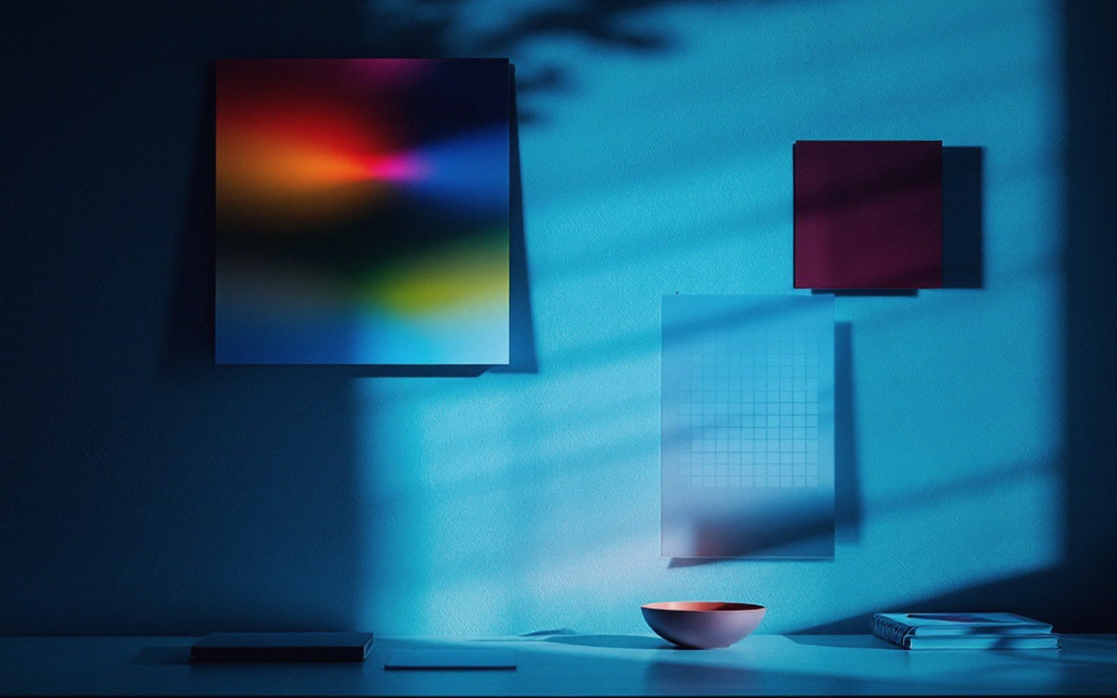 A monitor's glow lighting a dark wall